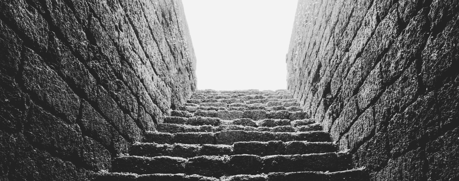 Captivating low-angle view of an ancient stone staircase with dramatic lighting.